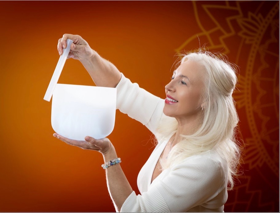 Lina holding a crystal singing bowl during a sound healing session